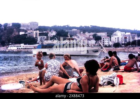 Costa Brava Fährschiff in den 1960er Jahren, auch bekannt als Seetaxfähren. Die Boote hielten an verschiedenen Haltestellen entlang der Küste, die von den Stränden aus über Leitern am Bug jedes Schiffes erreicht wurden. Cruceros-Service hält an Tossa de Mar, Lloret de Mar, Blanes, Calella, Stockfoto