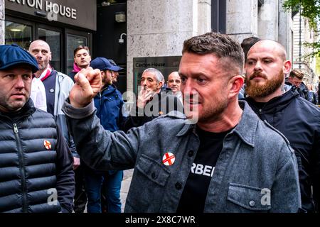 Nachdem Tommy Robinson Einen Prozess gegen die Met Police gewonnen hat, verlässt er zusammen mit seinem Sicherheitsteam Eine St Georges Day Rally in London. Stockfoto