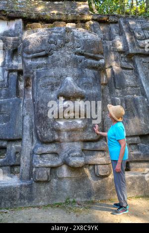 Touristen auf der Suche auf Stuck-Maske, Maske Tempel, Maya-Stätte Lamanai, Belize Stockfoto