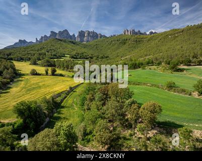 Aus der Vogelperspektive auf den Berg Montserrat von den Feldern rund um Sant Esteve de Marganell im Frühling (Bages, Barcelona, Katalonien, Spanien) Stockfoto