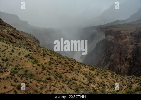 Der Tonto Trail wendet die Ecke mit Nebel, der tief über den Colorado River im Grand Canyon hängt Stockfoto