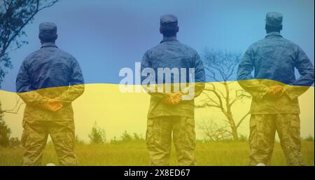 Drei Männer in Militäruniformen stehen im Feld und zeigen sich weg Stockfoto