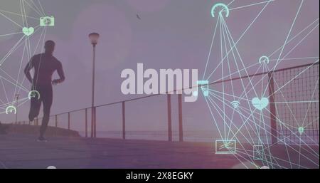 Bild von vernetzten Ikonen, die Kugeln über afroamerikanischen Männern bilden, die am Strand laufen Stockfoto