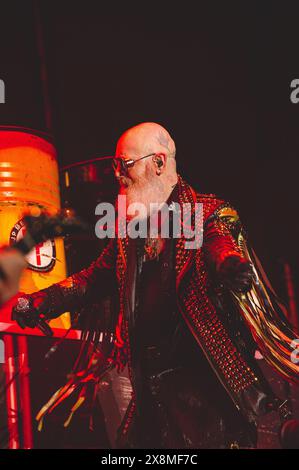 Eine Reihe von elektrisierenden Fotos von Judas Priest live, die den legendären Heavy Metal-Stil, die dramatische Beleuchtung und die intensive Performance-Energie hervorheben. Stockfoto