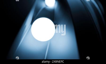 Bewegliche glühende 3D-Kugeln. Design. 3D-Kugeln leuchten und Rollen auf der Schiene. Animation mit 3D-Kugeln, die im Dunkeln leuchten und sich im Tunnel bewegen Stockfoto