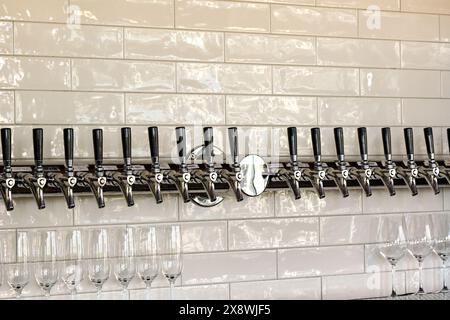 Reihe von Zapfhähnen in einer Weinbar zum Abgeben verschiedener Weinsorten im Glas Stockfoto