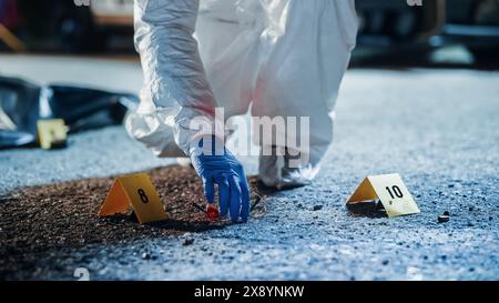 Forensik Team in Aktion: Experte für Overalls, die Beweise aus einer Kriminalszene holen und eine Platic Bag mit Reißverschluss verstauen. Broken Bloody Brille, die möglicherweise dem Mörder gehört und als Hinweis verpackt wird Stockfoto