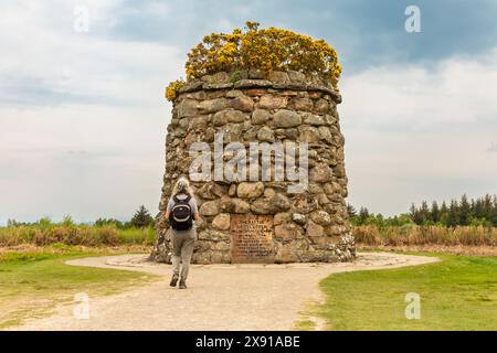 Eine Frau nähert sich dem Gedenkstein auf dem Schlachtfeld von Culloden in der Nähe von Inverness, Schottland. Die letzte blutige Schlacht auf britischem Boden fand 1745 statt. Stockfoto