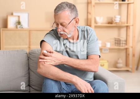 Seniorin mit Glukosesensor zur Messung des Blutzuckerspiegels zu Hause. Diabeteskonzept Stockfoto