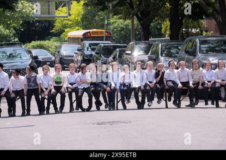 Eine Klasse orthodoxer jüdischer Jungen wartet auf Bänken auf den Beginn der lag B'Omer 2024-Feierlichkeiten in Brooklyn, New York. Stockfoto