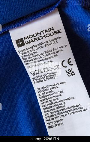 Waschpflegesymbole Anweisungen auf dem Etikett des Mountain Warehouse-Labels auf dem blauen, ableitenden T-Shirt T-Shirt T-Shirt T-Shirt - CE-Kennzeichnung CE-Zeichen CE-Zeichen CE-Logo Stockfoto