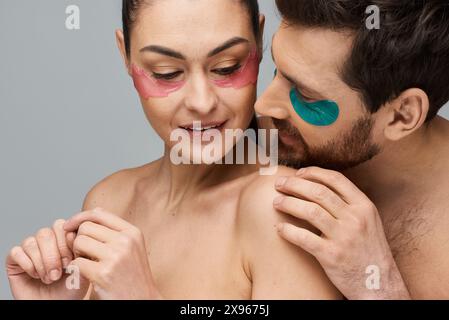 Fröhliches Paar mit Augenflecken posiert zusammen in einer zauberhaften Präsentation. Stockfoto