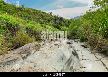 Wandern Sie auf einem alten Lavastrom, jetzt ein glattes erodiertes Flussbett und Wanderweg zum Vulkan Lokon, in der Nähe von Tomohon City, Gunung Lokon, Tomohon, Nord-Sulawesi Stockfoto