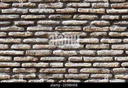 Alte graue Ziegelwand, Vorderansicht, nahtlose Hintergrundfotostruktur Stockfoto