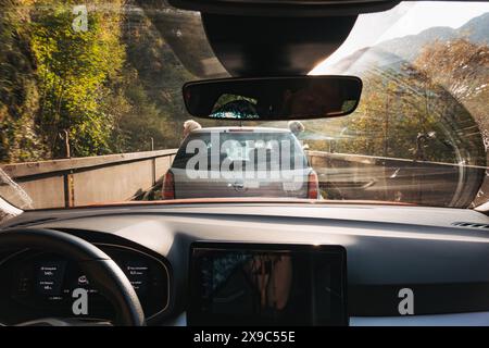 Der Blick aus dem Inneren eines Autos, das mit der Mororail durch die Landschaft Sloweniens fährt. Zwei Jungs lehnen sich aus dem Auto vor dem Fenster Stockfoto