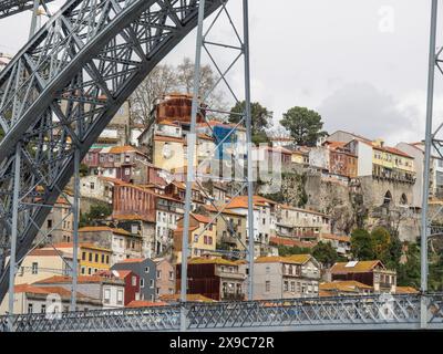 Blick auf eine Bergstadt mit bunten Häusern und einer großen Brücke im Vordergrund, farbenfrohe Häuser auf einem Fluss mit bunten Booten und eine große Brücke Stockfoto