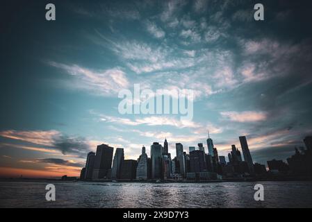 Skyline von Lower Manhattan vom East River bei Sonnenuntergang - New York City aus gesehen Stockfoto