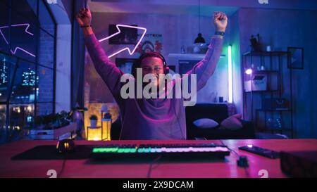 Gaming zu Hause: Afroamerikanischer Spieler feiert nach dem Sieg in Online-Videospiel am Computer. Erfolgreicher Black man gewinnt beim Online-Multiplayer-Turnier. POV aus Bildschirmperspektive. Stockfoto