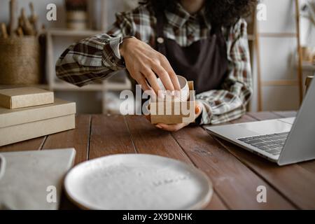 Der Unternehmer verkauft Teller, Teller und Tassen aus Ton Stockfoto