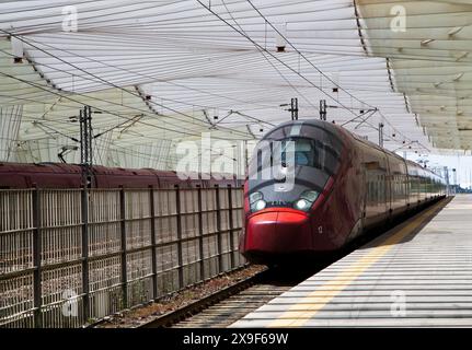 Der Hochgeschwindigkeitszug fährt in den Bahnhof Reggio Emilia AV Mediopadana ein, der in Italien fortgeschrittene Eisenbahnverkehr ist. Stockfoto