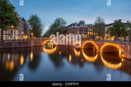 Die Kreuzung Leidsegracht und Keizersgracht in einer stillen Nacht im Mai 2024 bei Dämmerung in Amsterdam, Niederlande. Stockfoto