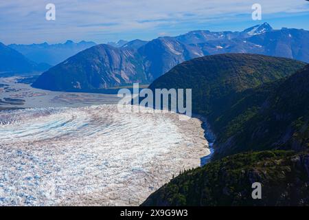 Aus der Vogelperspektive auf die Gletscher entlang des Taku Inlet, die Teil des Juneau Icefield in Alaska, USA sind - kurviger Eisstrom bedeckt mit Scherung Stockfoto