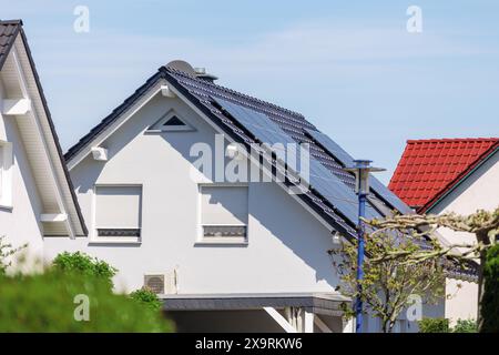 Stadtstraße Einfamilienhaus moderne Häuser Solar-Photovoltaik-Panels Dach Deutschland vor blauem Himmel. Deutsche Vorstadtsiedlung in Kleinstadt ROW ECO Stockfoto