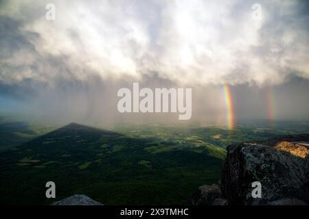 Ein Regenbogen ist vom Gipfel des Sharp Top Mountain bei Sonnenuntergang in den Blue Ridge Mountains in Virginia zu sehen Stockfoto