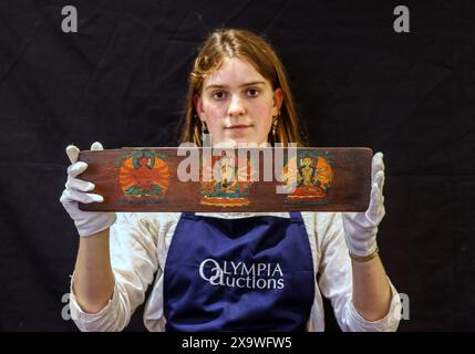Olympia Auctions, London, Großbritannien. Juni 2024. Ein Paar bemalte Holzbucheinzüge, Tibet, 15./16. Jahrhundert, jeweils in langer rechteckiger Form, die leicht konvexen Außenfassungen mit einfacher Vertäfelung, die Innenseiten mit verschiedenen buddhistischen Gottheiten bemalt, eine mit der zentralen Figur des Buddha flankiert von Padmapani und Manjusri und zwei der fünf tantrischen Tathagaten, die übrigen drei auf der anderen Seite sind 11,2 x 51 cm, ca. 400-600 €, Auktion 5. Juni 2024. Quelle: Paul Quezada-Neiman/Alamy Live News Stockfoto