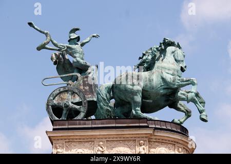 Statuen auf dem Heldenplatz in Budapest. Hősök tere (Ungarisch: [ˈhøːʃøk ˈtɛrɛ]; lit. „Heldenplatz“) ist einer der wichtigsten Plätze in Budapest, Ungarn, bekannt für sein ikonisches Millenniums-Denkmal mit Statuen der sieben Häuptlinge der Magyaren und anderer wichtiger ungarischer Nationalführer, sowie den Gedenkstein der Helden, der fälschlicherweise als Grab des unbekannten Soldaten bezeichnet wird. Der Platz liegt am ausgehenden Ende der Andrássy Avenue neben dem Stadtpark (Városliget). Hier befinden sich das Museum der Schönen Künste und der Kunstpalast (Műcsarnok). Stockfoto