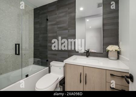 Ein weißes Badezimmer mit Eckdusche und Wanne Stockfoto
