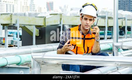 Ein Ingenieur, der auf einem Walkie-Talkie auf einer Baustelle spricht. Stockfoto