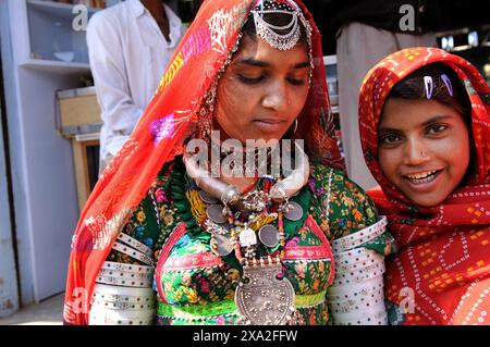 Farbenfrohe Rajasthani-Frauen besuchen ein lokales Marktdorf in der indischen Wüste in Rajasthan, Indien. Stockfoto