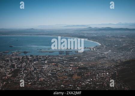 Erfassen Sie die atemberaubende Schönheit von Kapstadt mit dieser hochauflösenden Luftaufnahme, die die Stadt, den Hafen und die umliegenden Berge zeigt. Perfekt für Stockfoto