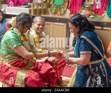 Bei einem Valaikappu-Service ist es üblich, Armbänder an das Handgelenk der Mutter zu legen. Das Geräusch stimuliert die Sinne und Gehirnaktivität des Babys. Stockfoto