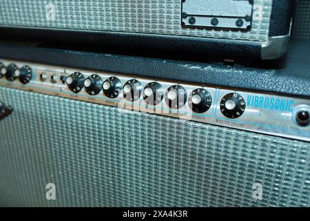 Nahaufnahme eines Vintage Vibrosonic Gitarrenverstärkers mit Bedienknöpfen und strukturiertem Kühlergrill. Stockfoto