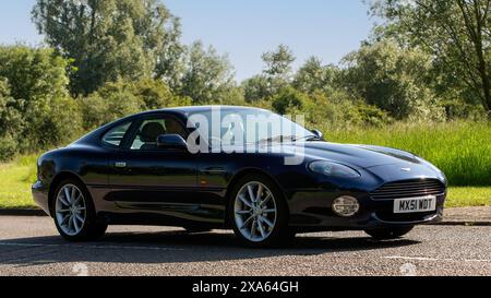 Stony Stratford, UK - 2. Juni 2024: 2001 blauer Aston Martin DB7 klassischer britischer Wagen, der auf einer britischen Landstraße fährt Stockfoto