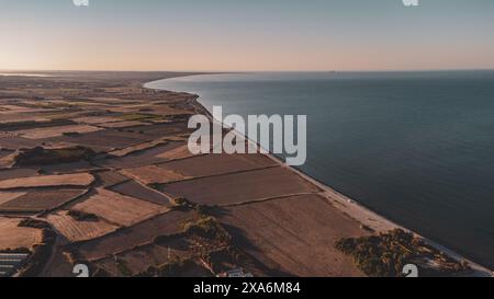Aus der Vogelperspektive auf den Sonnenuntergang über der Farm und den unbefestigten Hügeln im Kourion Amphitheater, Zypern Stockfoto