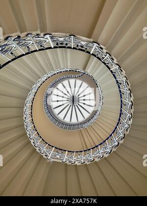 Eine Wendeltreppe mit blauen Handläufen und Glaskuppel Stockfoto