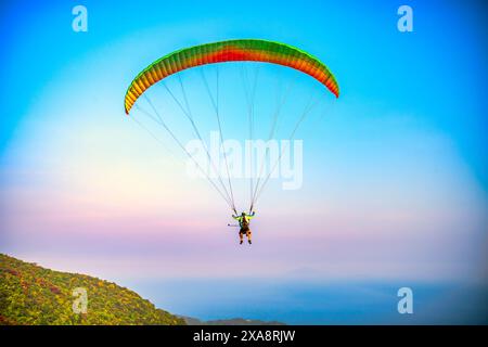 Die Paragliding-Tour beginnt am Gipfel des Son Tra Berges und landet am da Nang Strand für Touristen, die den Nervenkitzel in da Nang, Vietnam, erkunden möchten Stockfoto