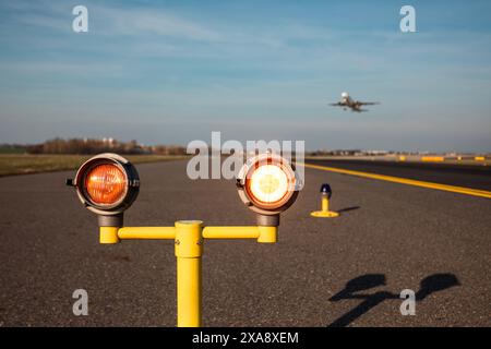 Verkehr am Flughafen an sonnigen Tagen. Nahaufnahme der Sicherheitsleuchten, die vor der Start- und Landebahn des Flughafens warnen. Stockfoto