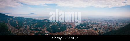 Eine Skyline der Stadt mit fernen Bergen und bewölktem Himmel Stockfoto