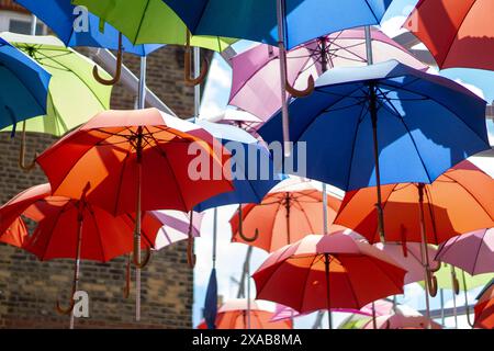 Bunte Regenschirme hingen über den Märkten Stockfoto