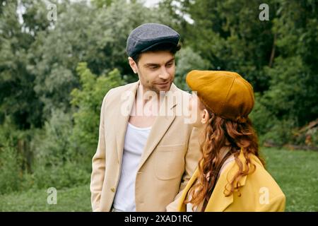 Ein Mann und eine Frau stehen nebeneinander und umarmen sich liebevoll in einem wunderschönen grünen Park bei einem romantischen Date. Stockfoto