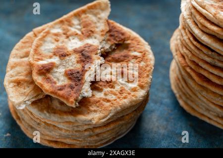 Fladenbrot Lavash, Chapati, Naan, ein Haufen Tortilla auf blauem Hintergrund hausgemachtes Fladenbrot gestapelt Stockfoto