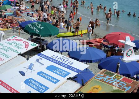 Spiaggia di Fegina, die Grenze des öffentlichen Strandes mit Menschen und Schwimmern und Ständen für Liegen oder Kajaks, Monterosso, Cinque Terre Stockfoto