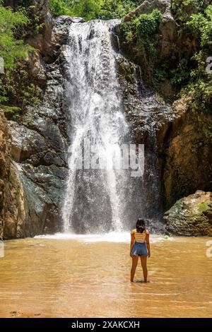 Nordamerika, Karibik, Insel Hispaniola, Dominikanische Republik, Provinz La Vega, Jarabacoa, attraktive Latina steht im Wasserbecken vor dem Wasserfall Salto Baiguate Stockfoto