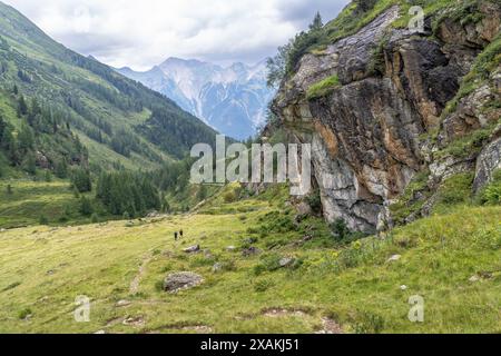 Europa, Österreich, Verwall, Tirol, Pettneu am Arlberg, Bergwanderer, die durch das grüne Malfontal absteigen Stockfoto