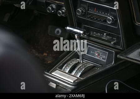 Automatische Gangschaltung im Cockpit eines Oldtimers, schwarz-silberner Innenraum mit Radio, Heizung und Uhr, Kopierraum, ausgewählter Fokus Stockfoto