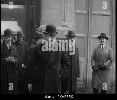 Der französische Premierminister Aristide Briand stand draußen mit einer Gruppe männlicher Zivilisten in Hüten, 1926. "So instabil Deutschland auch schien, die anderen westlichen Nationen hielten es für angebracht, sie in den Völkerbund aufzunehmen. "Besser rein als raus", sagten viele. Traditionelle Gegner Deutschlands wie Frankreich behielten ihre wahren Gedanken für sich, aber sie ließen sie trotzdem rein. Aus „Time to Remember 1926 – Short Sharp Shower“ – Reel 1; ein Dokumentarfilm über 1926 – General Strike, internationale Politik, Tanz, Wetter und rekordbrechende Meisterleistungen. Stockfoto